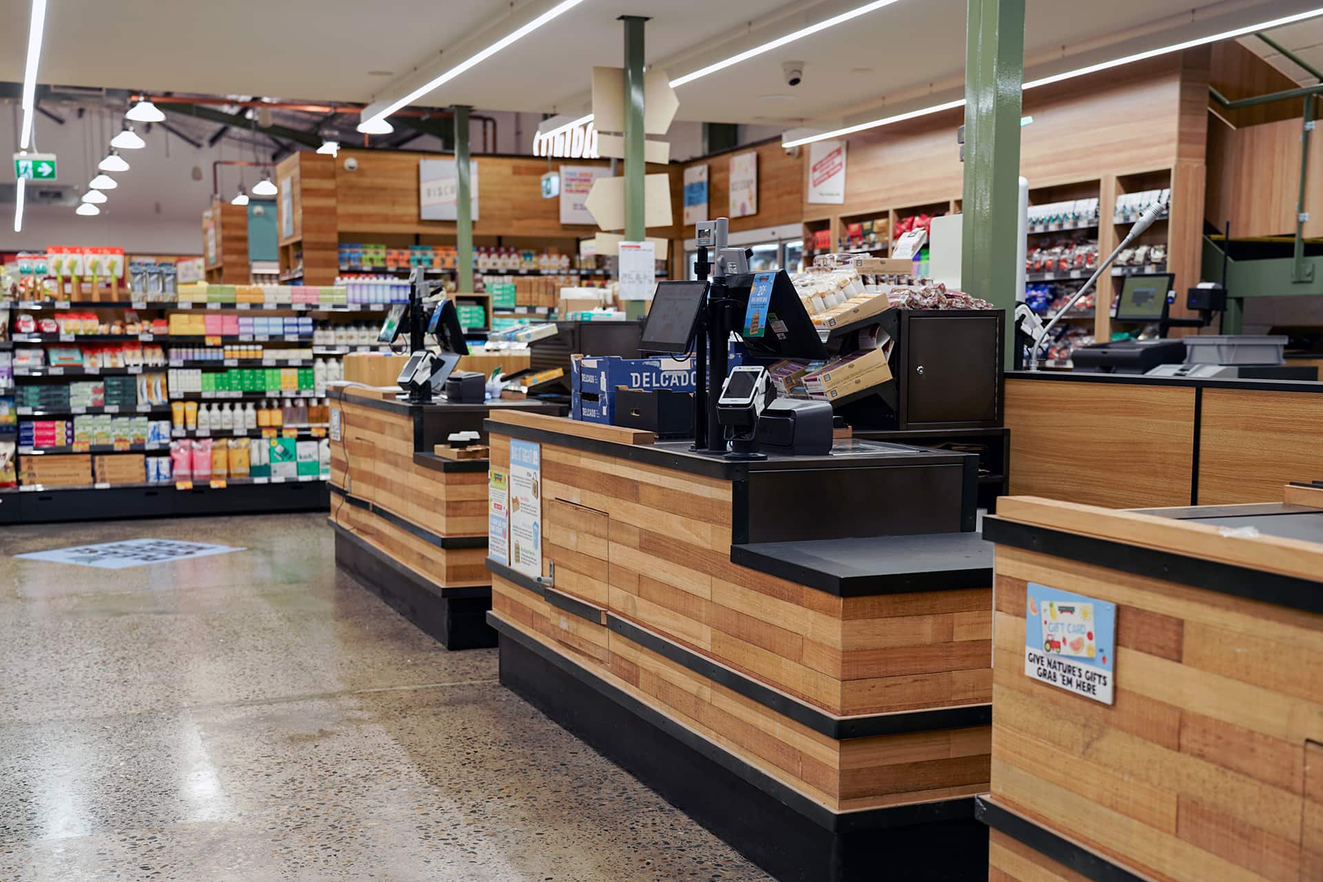Cash register with a custom wood exterior inside a supermarket